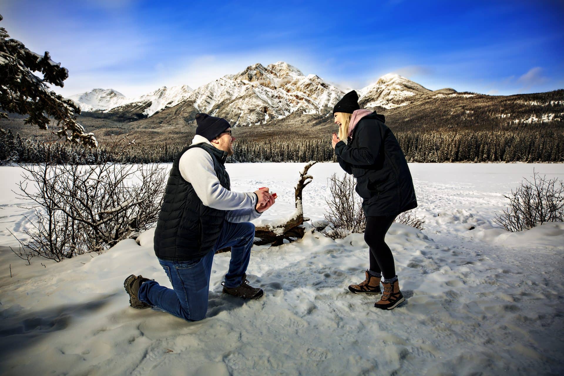 man on one knee proposing to a surprised woman | Best proposal locations in Jasper