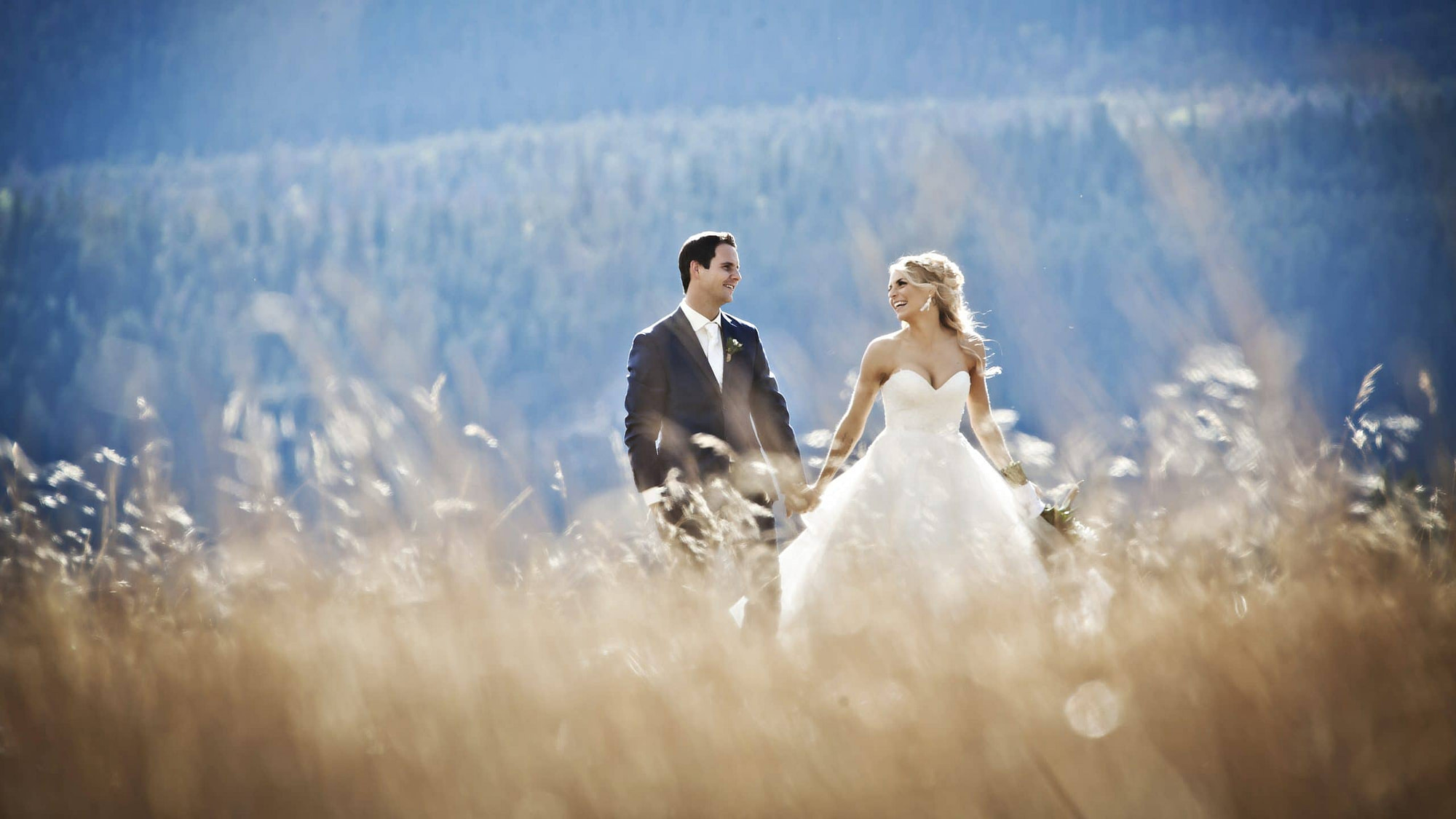 wedding couple walking in the tall grass at the Athabasca Day Use area | Jasper photographers