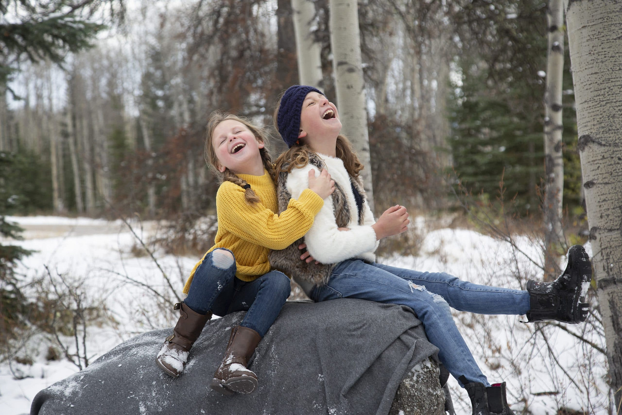 two little girls laughing and hugging on a rock | Jasper family photographers