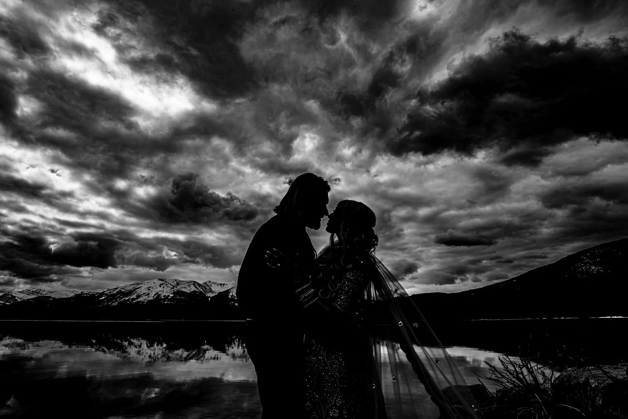 silhouette of man and woman with clouds in the background -8 uses for your Jasper engagement photos