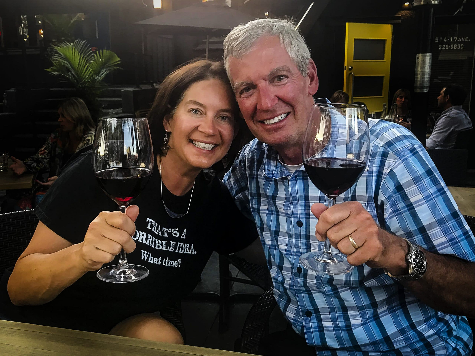 couple having a glass of red wine and smiling at camera|Jasper photographer