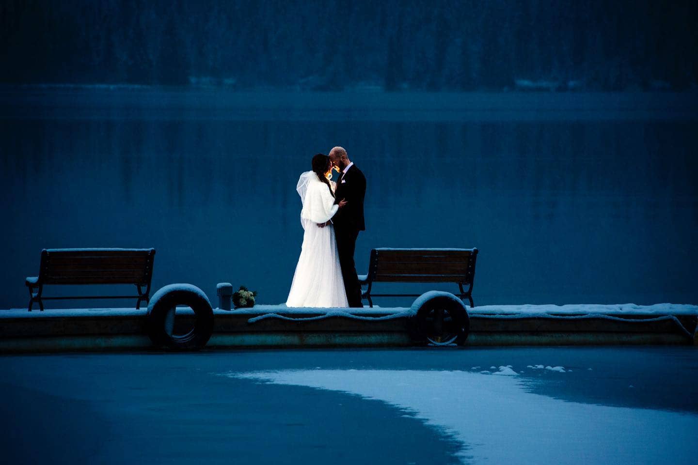 wedding couple standing on dock at night time- evening portraits at your Jasper wedding