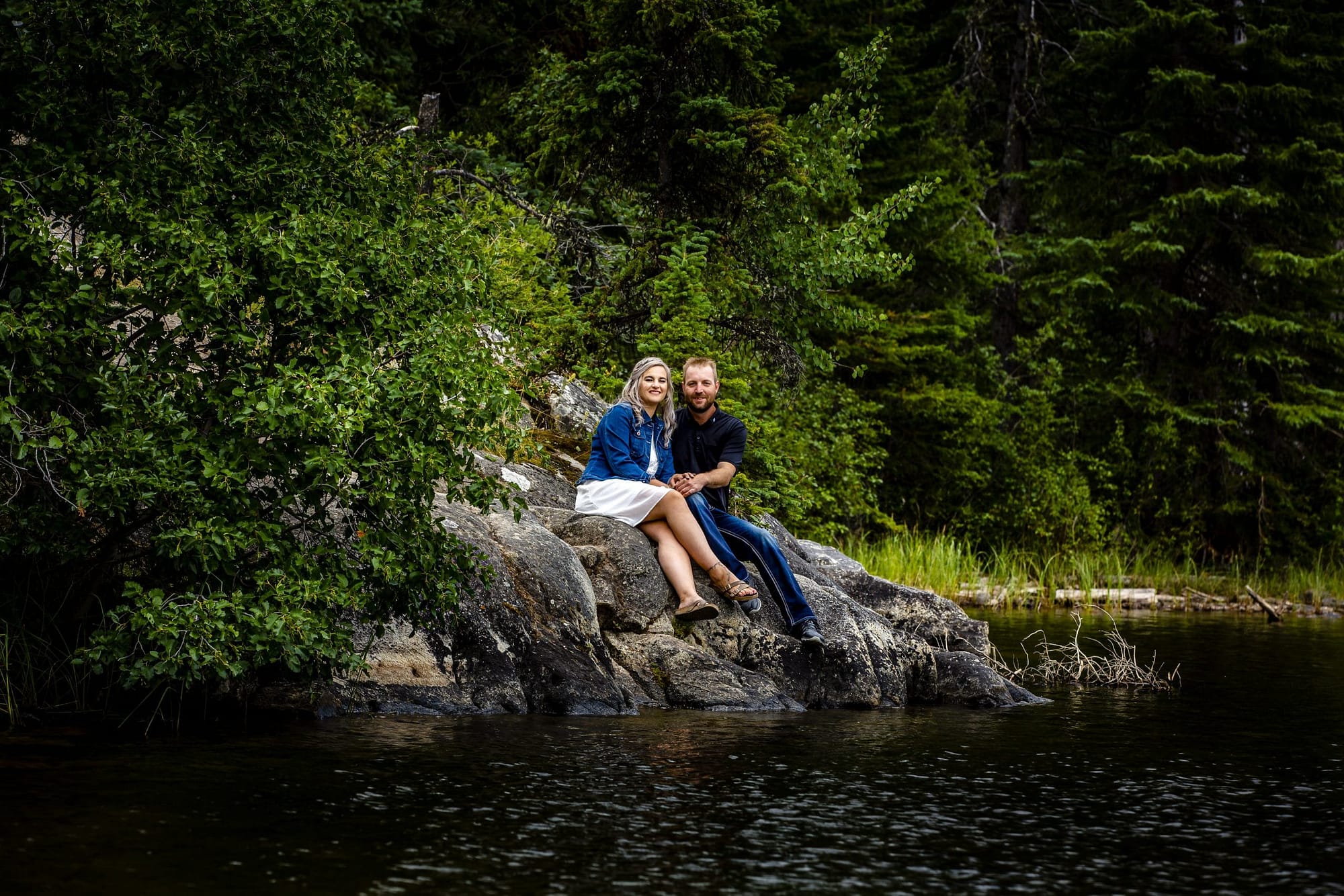 couple sitting on the rocks and looking at the camera-pyramid island engagement session